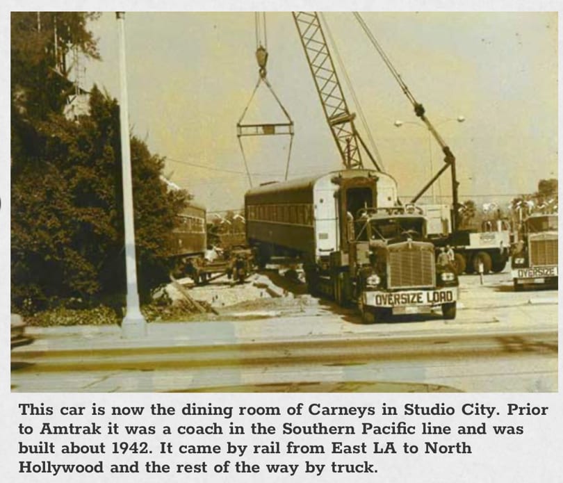 Vintage photo of a train car being transported by an "Oversize Load" truck and crane.